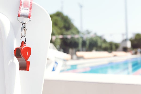Whistle hanging on a chair near a pool
