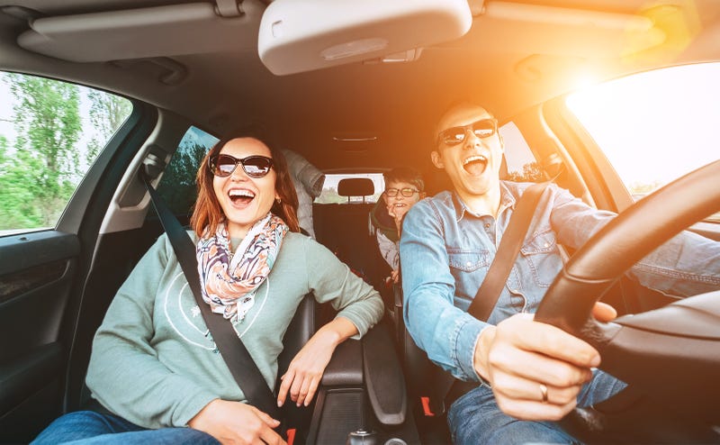 Family laughing in car.