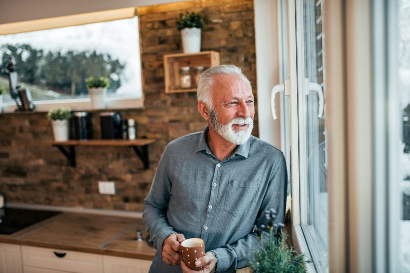 older man looking out of window