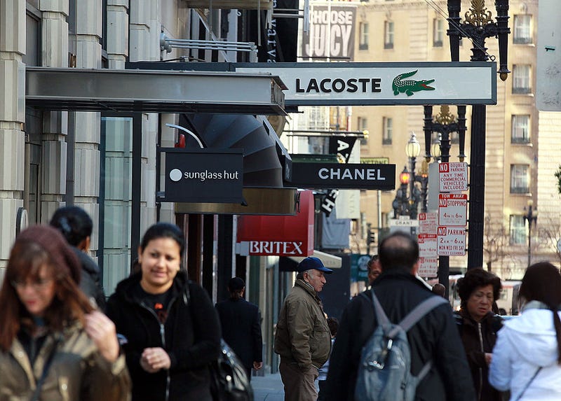 Pedestrians walk by shops near Union Square on February 22, 2011 in San Francisco, California.