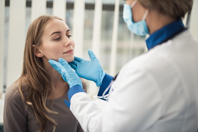 A doctor checks a patient for illness