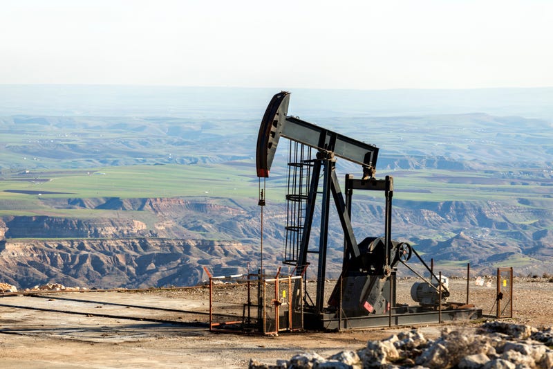 An oil rig in mountainous terrain