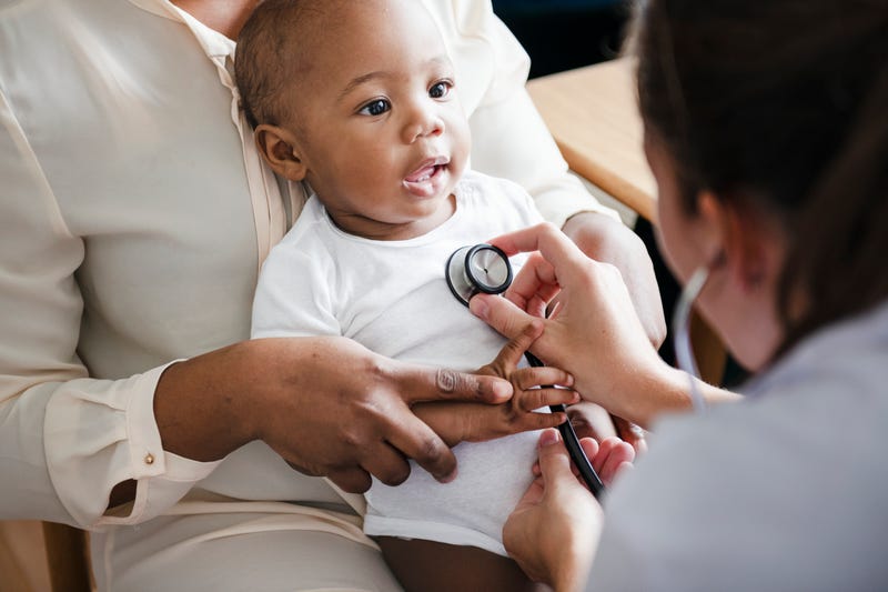A doctor gives a check-up to a baby