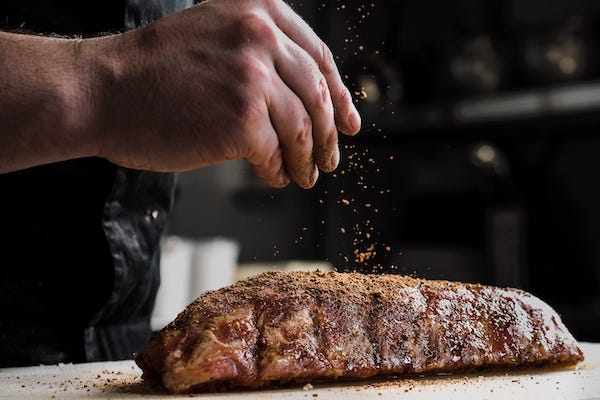 Man seasoning steak