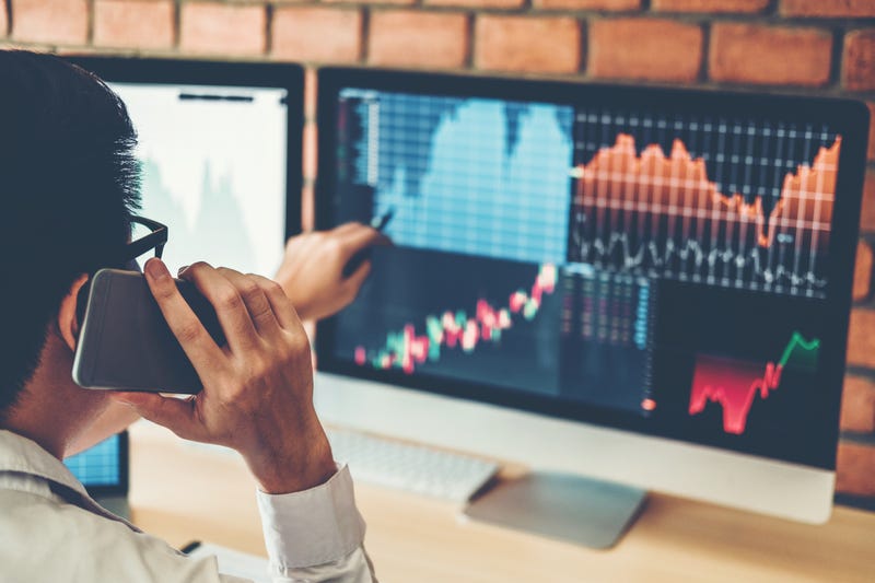 A man examines financial charts