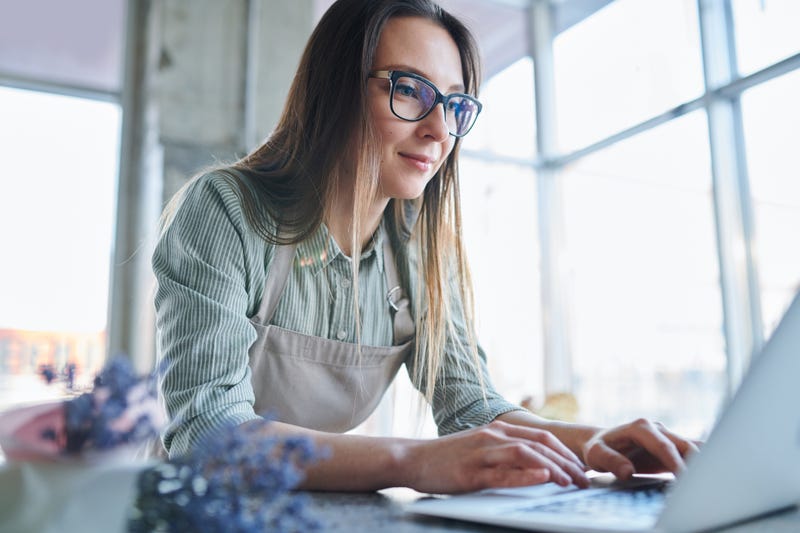 A woman works on a laptop