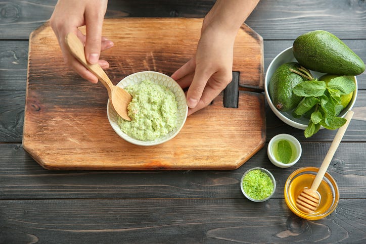 woman making avocado and honey face mask