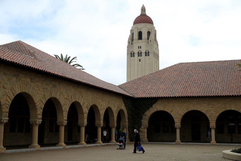 People walk by Hoover Tower on the Stanford University campus on March 12, 2019 in Stanford, California.