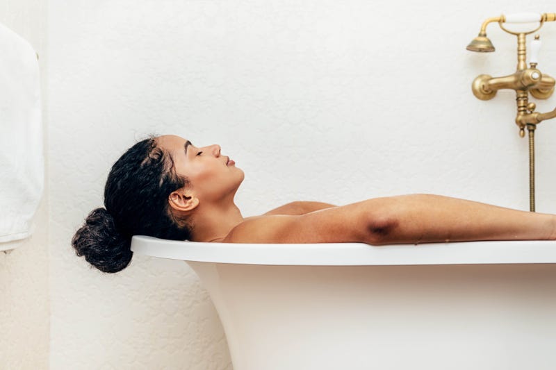 A woman relaxes in the bath