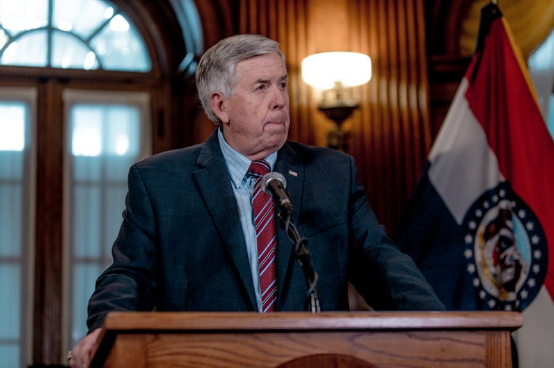 mike parson standing at a podium