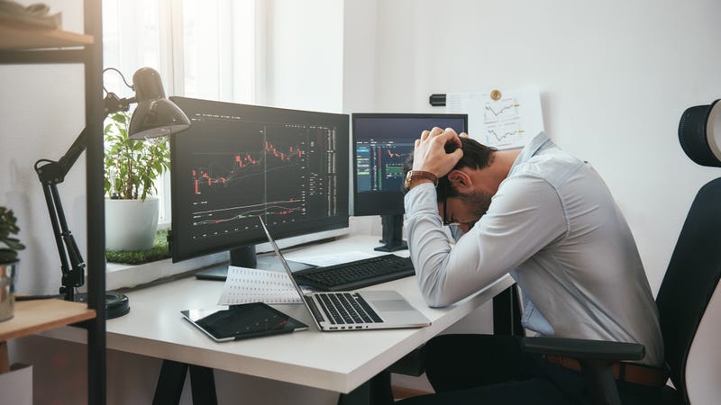 A man frustrated at economic graphs