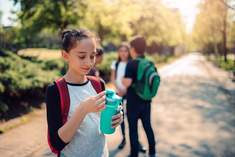 girl opens reusable water bottle