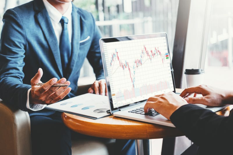 Two investors examine economic charts