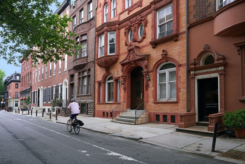 A bicyclist makes his way down a Philadelphia street.