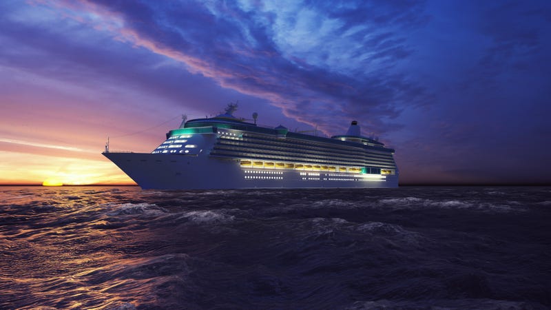 big cruise ship on the ocean at sunset