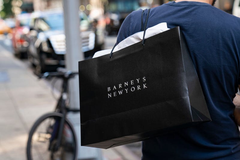 shopper in new york carrying barney's bag