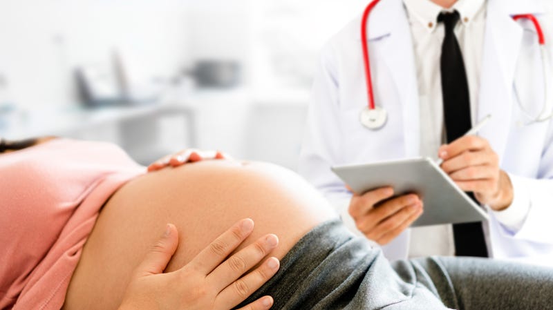 A pregnant woman consults with her doctor
