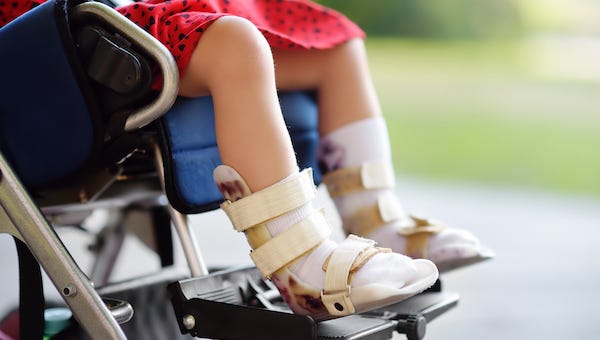 Child with cerebral palsy sitting in wheelchair