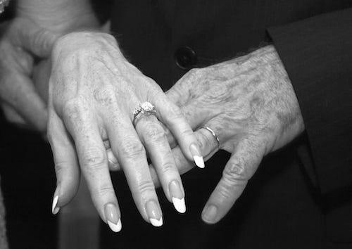 Elderly couple's hands during wedding