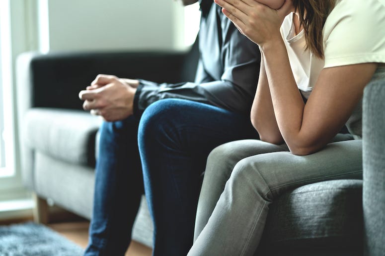 Couple arguing sitting on the couch