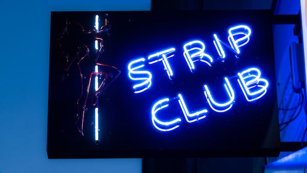 Neon sign of a strip club