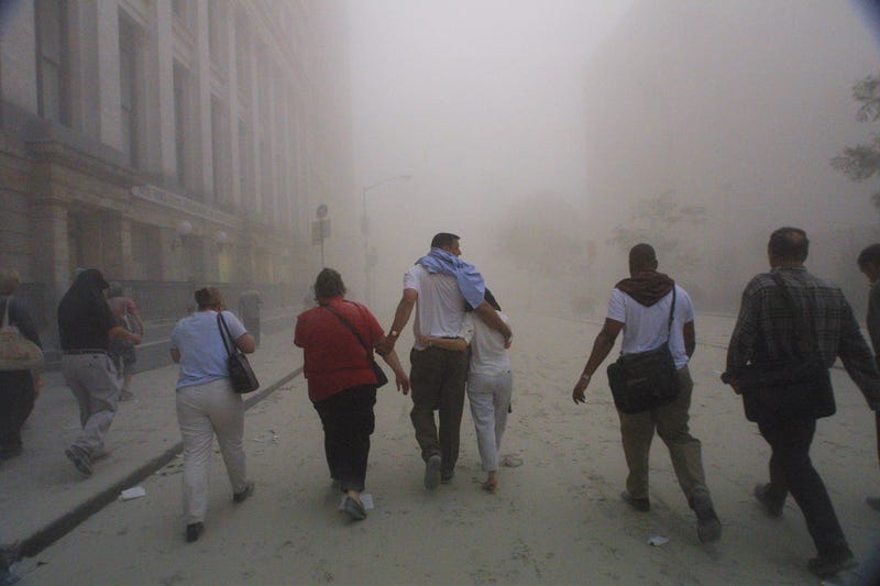 394261 50: Civilians flee as a tower of the World Trade Center collapses September 11, 2001 after two airplanes slammed into the twin towers in an alleged terrorist attack.