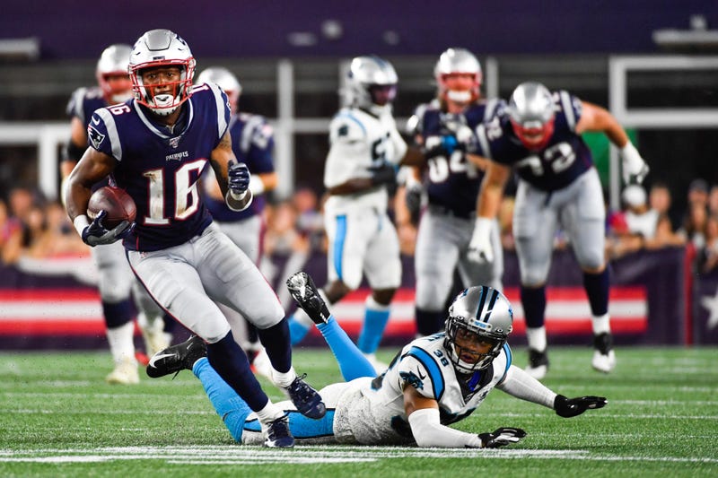 Jakobi Meyers #16 of the New England Patriots runs past Javien Elliot #38 of the Carolina Panthers in the second quarter of a preseason game at Gillette Stadium on August 22, 2019 in Foxborough, Massachusetts