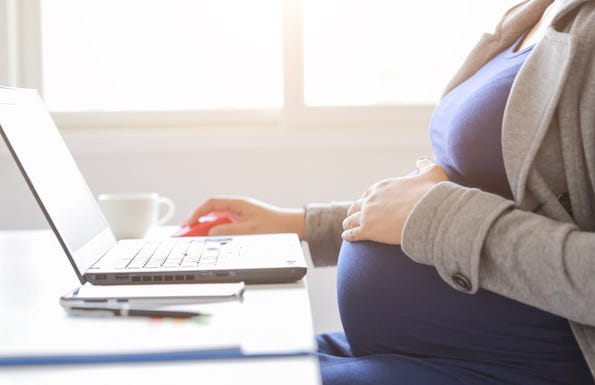 Pregnant woman working on laptop