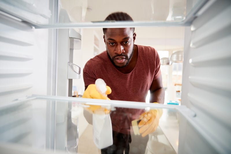 A man cleans his fridge