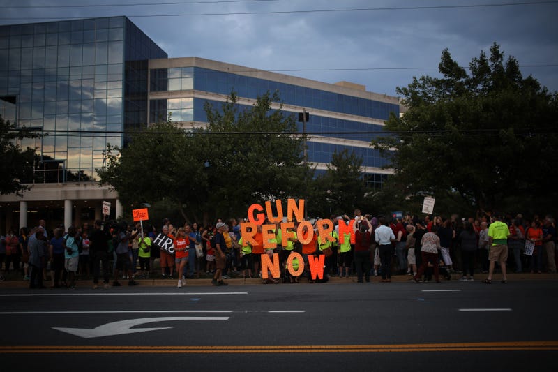A candle light vigil for gun victims outside the NRA's headquarters.