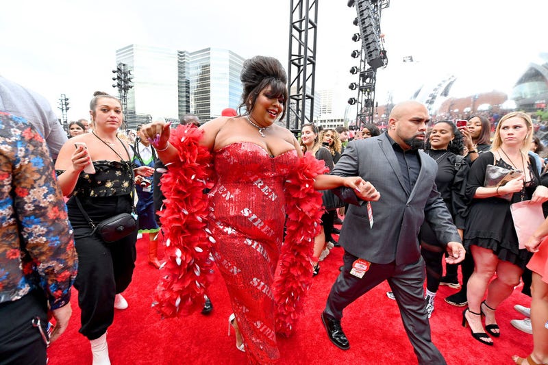 lizzo in red dress and boa at vmas