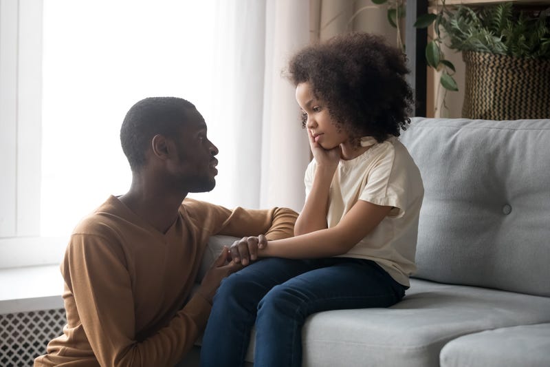A dad talks with his daughter