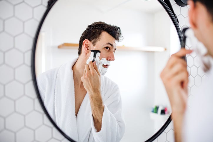 man shaving and grooming