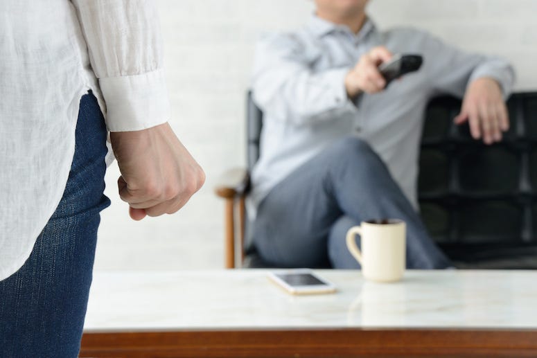 Woman frustrated with husband watching tv
