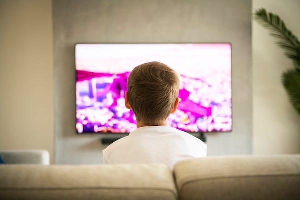 Back of boy's head watching TV