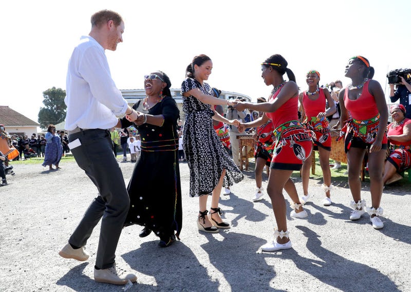 Prince Harry, Duke of Sussex and Meghan, Duchess of Sussex dance as they visit a Justice Desk initiative in Nyanga township, during their royal tour of South Africa on September 23, 2019 in Cape Town, South Africa. The Justice Desk initiative teaches children about their rights and provides self-defence classes and female empowerment training to young girls in the community.