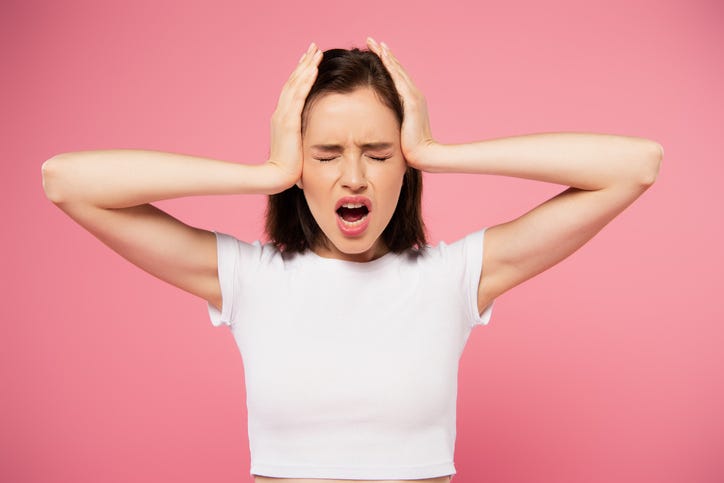 Woman covering her ears