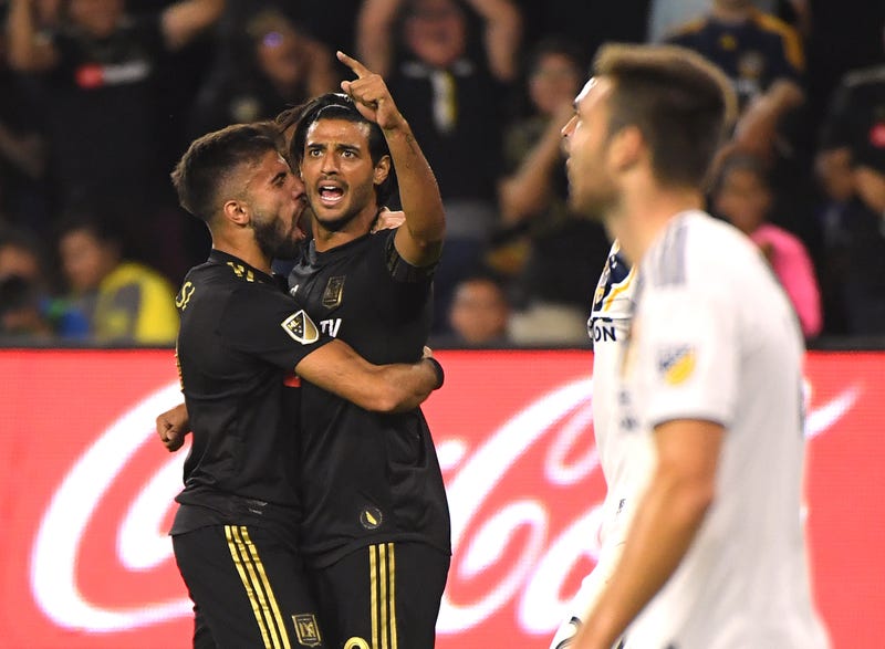 Carlos Vela #10 of Los Angeles FC celebrates his goal with Diego Rossi #9, to take a 1-0 lead over the Los Angeles Galaxy, during the first half of the Western Conference Semifinals at Banc of California Stadium on October 24, 2019 in Los Angeles, California.