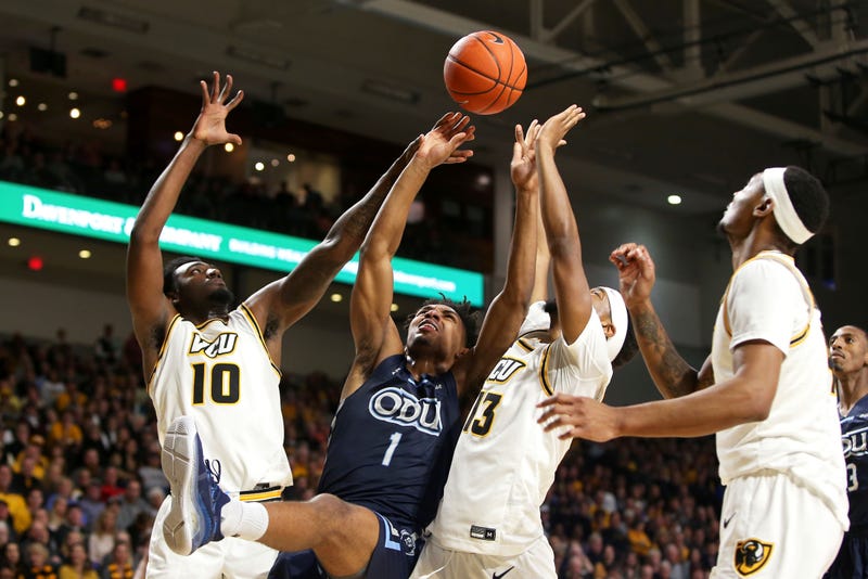 VCU and ODU men's basketball players battle for possession during a game between the Rams and Monarchs in 2019.