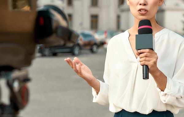 Female reporter during a live report