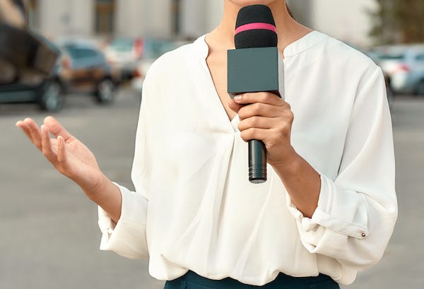TV reporter broadcasting live on location