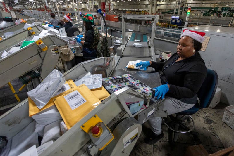 U.S. Postal Service workers scan parcels at the Los Angeles Processing and Distribution Center on December 11, 2019 in Los Angeles, California.