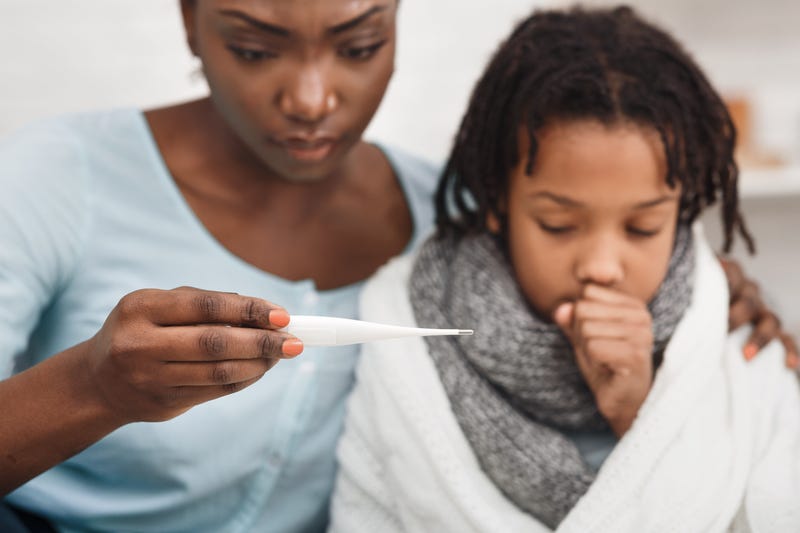 A mom checking her kid's temperature