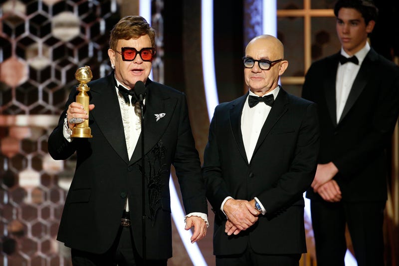Elton John and Bernie Taupin accept the award for their song "(I'm Gonna) Love Me Again"