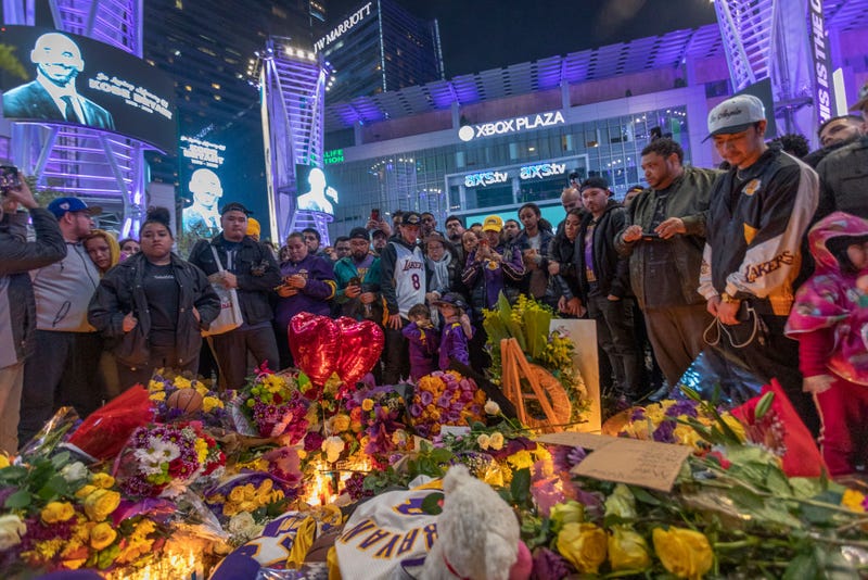 People mourn for former NBA star Kobe Bryant, who was killed in a helicopter crash in Calabasas, California, near Staples Center on January 26, 2020 in Los Angeles, California. Nine people have been confirmed dead in the crash, among them Bryant and his 13-year-old daughter Gianna.