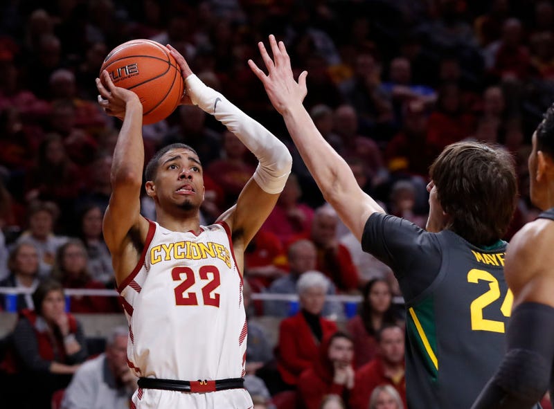 Tyrese Haliburton squares up for a shot with defense closing in.