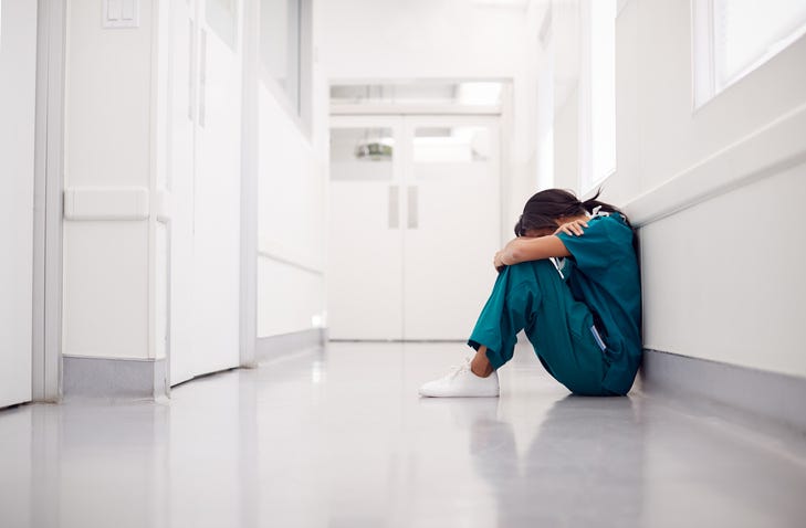 Stressed out health care worker in a hospital.
