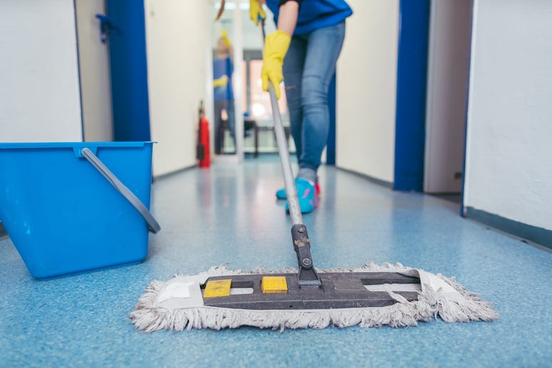 Custodian wiping floor