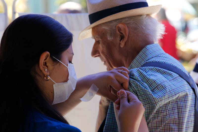 A nurse vaccinates a senior