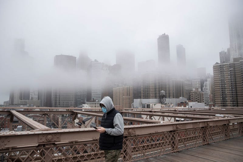 A man wearing a mask walks the Brooklyn Bridge in the midst of the coronavirus (COVID-19) outbreak